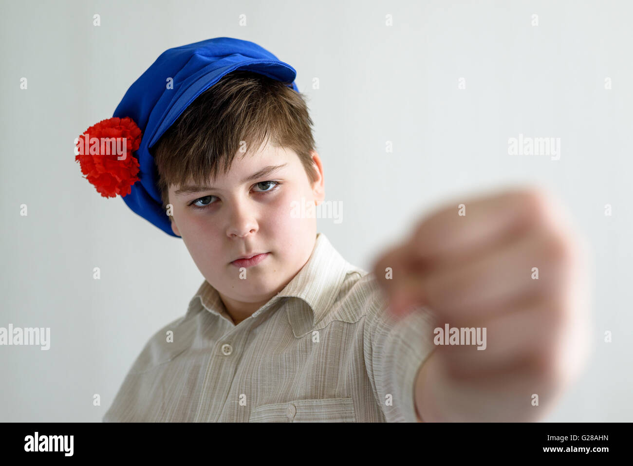 boy teenager in Russian national cap with cloves showing a fist Stock