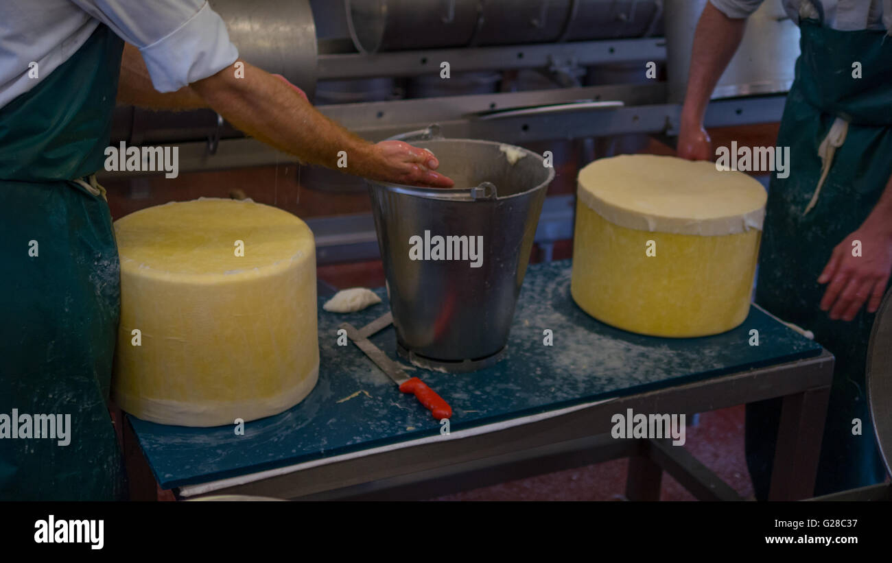 Two cheese makers cleaning cheese Stock Photo Alamy