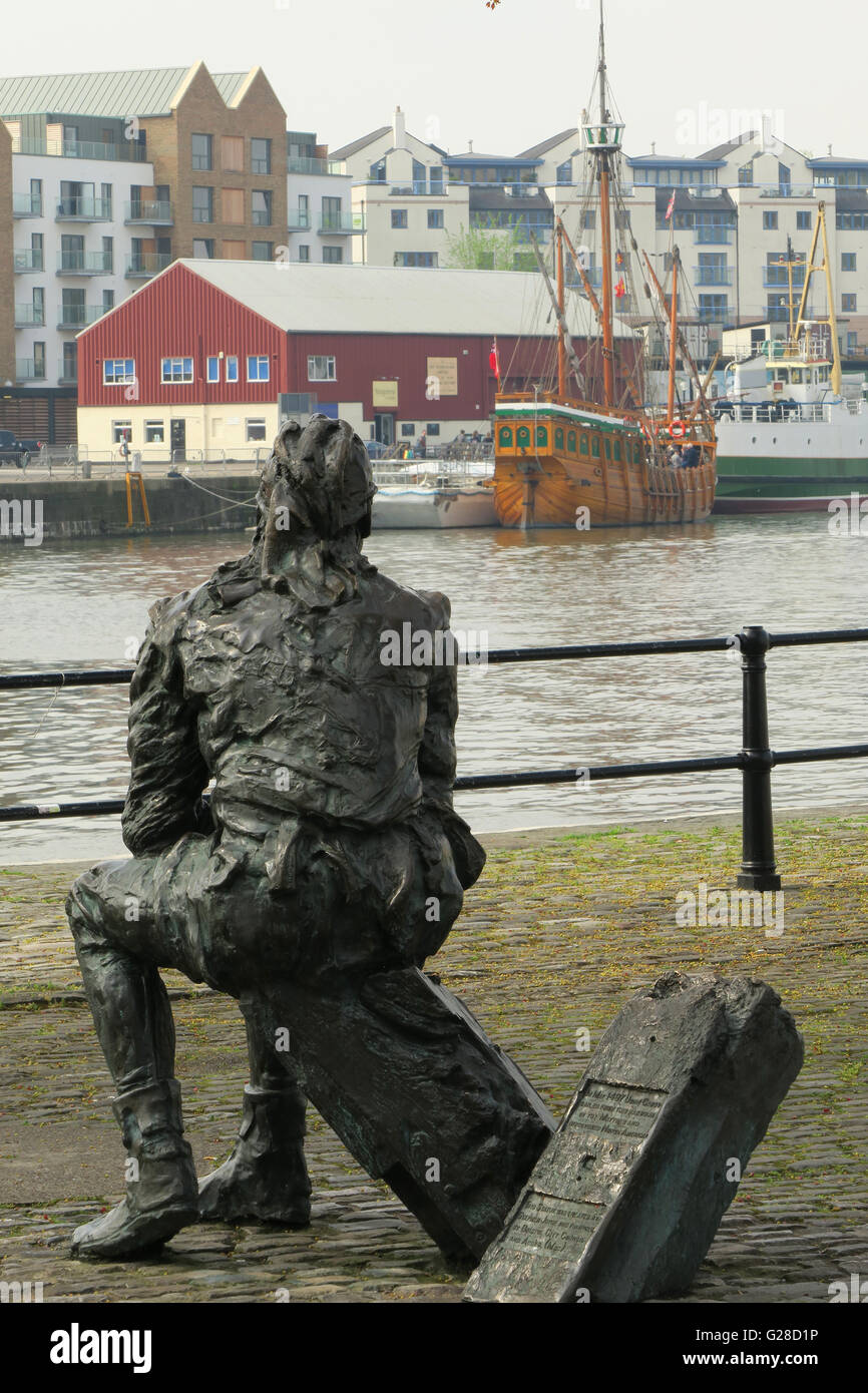 Bronze statue of John Cabot in Bristol UK opposite a replica of the sailing ship Matthew, in which he discovered North America in 1497 Stock Photo