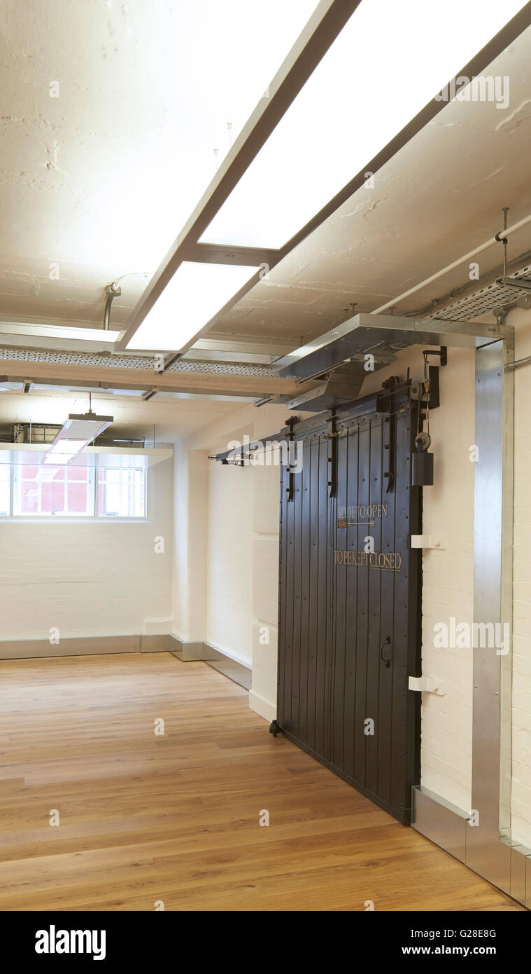 Original sliding warehouse doors. Heal's, Torrington Place, London, United Kingdom. Architect: John McAslan & Partners, 2014. Stock Photo