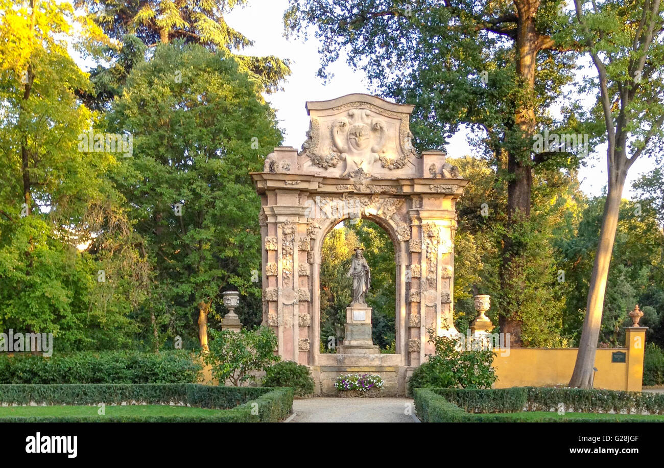 Park in Florence, Italy with ornate sculpture surround by a wooded area, Stock Photo