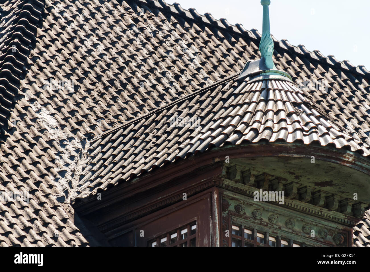 Geometrical shapes created by a tiled roof of an old house Stock Photo