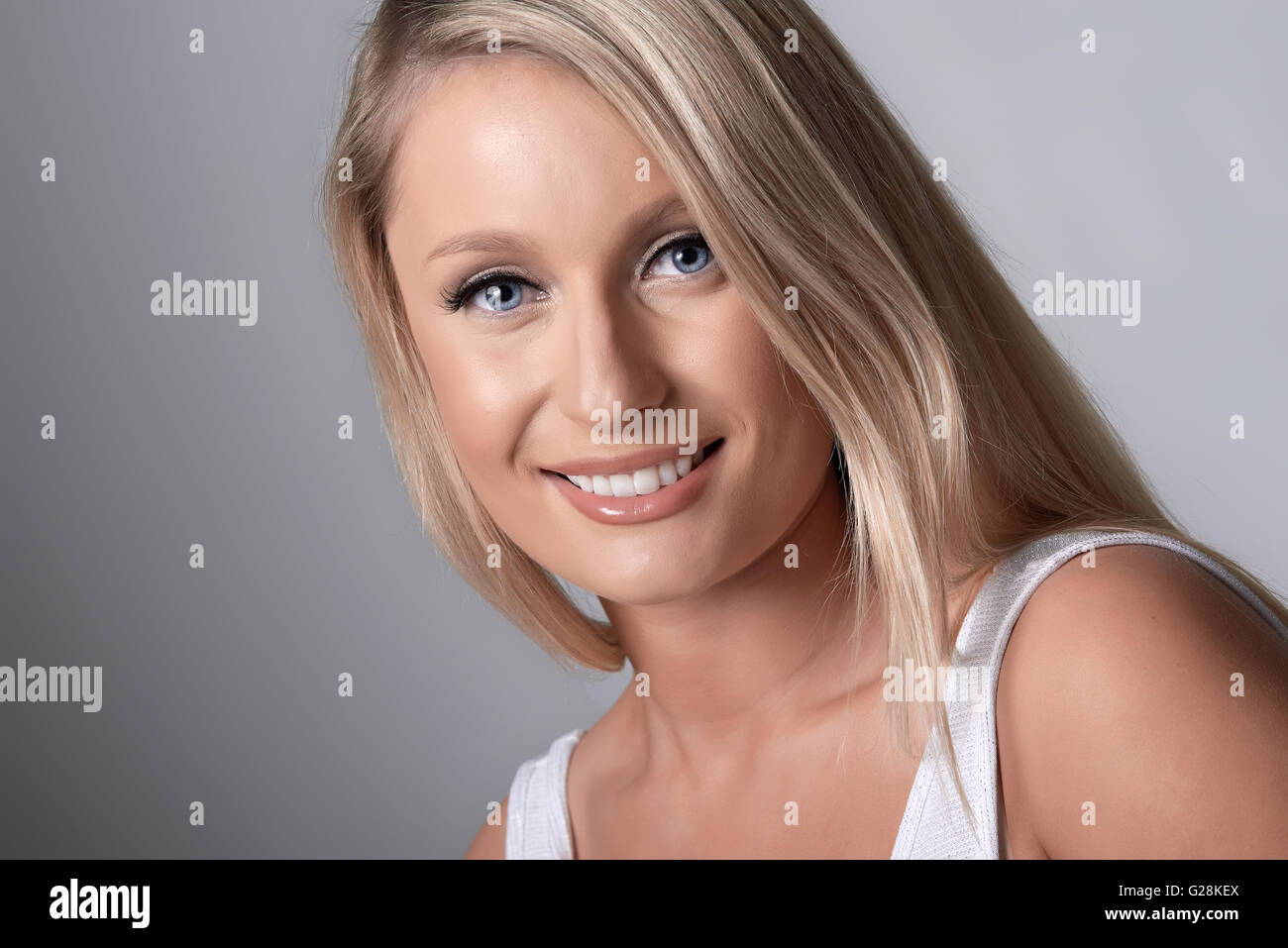 Portrait of beautiful blond model on grey background Stock Photo Alamy