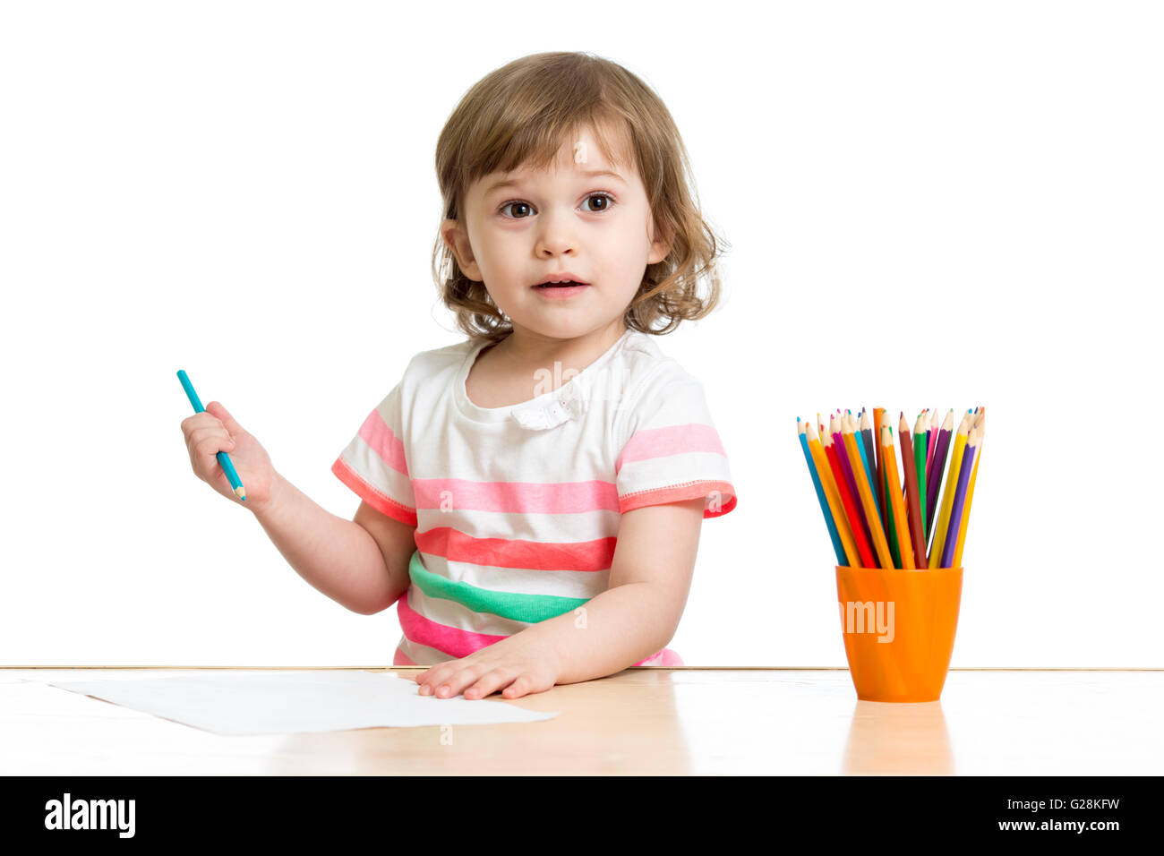Happy kid little girl drawing with pencils in preschool Stock Photo