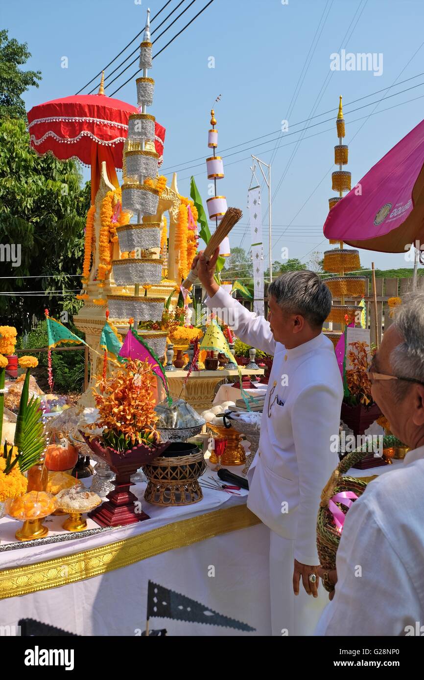 Chiang Mai, Thailand - May 15, 2016. Brahmin priest sprays lustral water over offerings at spirit house establishing ceremony. Stock Photo