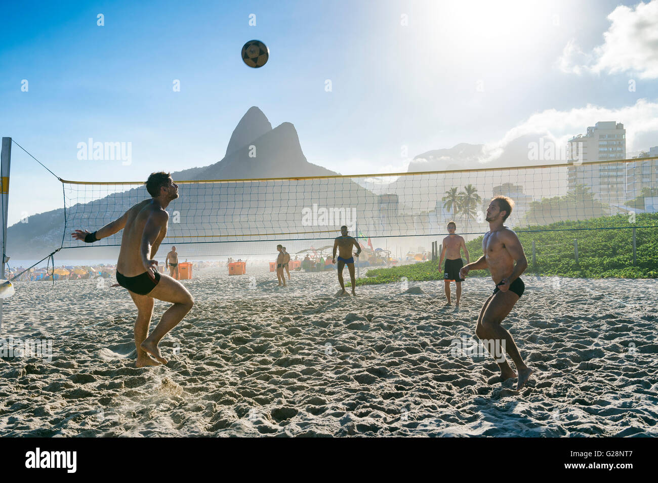 RIO DE JANEIRO - MARCH 27, 2016: Brazilians play futevôlei (footvolley, a sport combining football/soccer and volleyball). Stock Photo