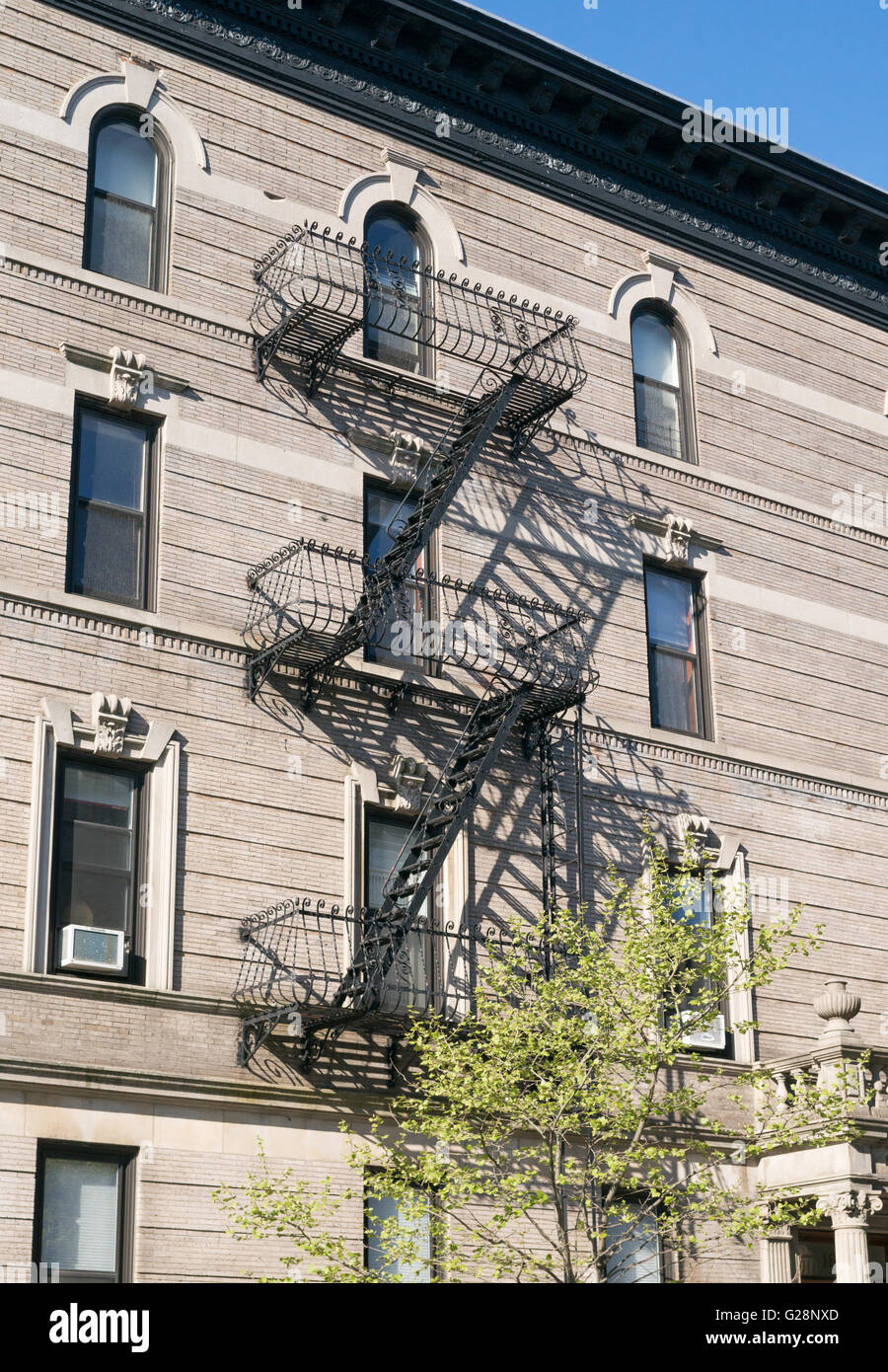 Metal fire escape with shadow apartment building, Park Slope, Brooklyn, New York, USA Stock Photo