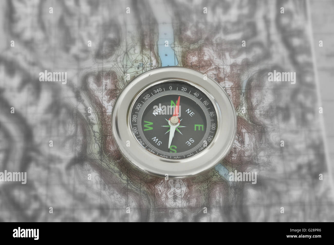 Orienteering using a map and compass. compass on a topographic