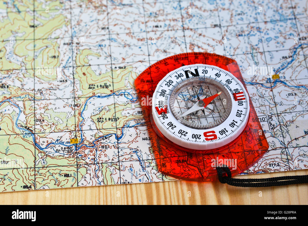 Orienteering using a map and compass. compass on a topographic