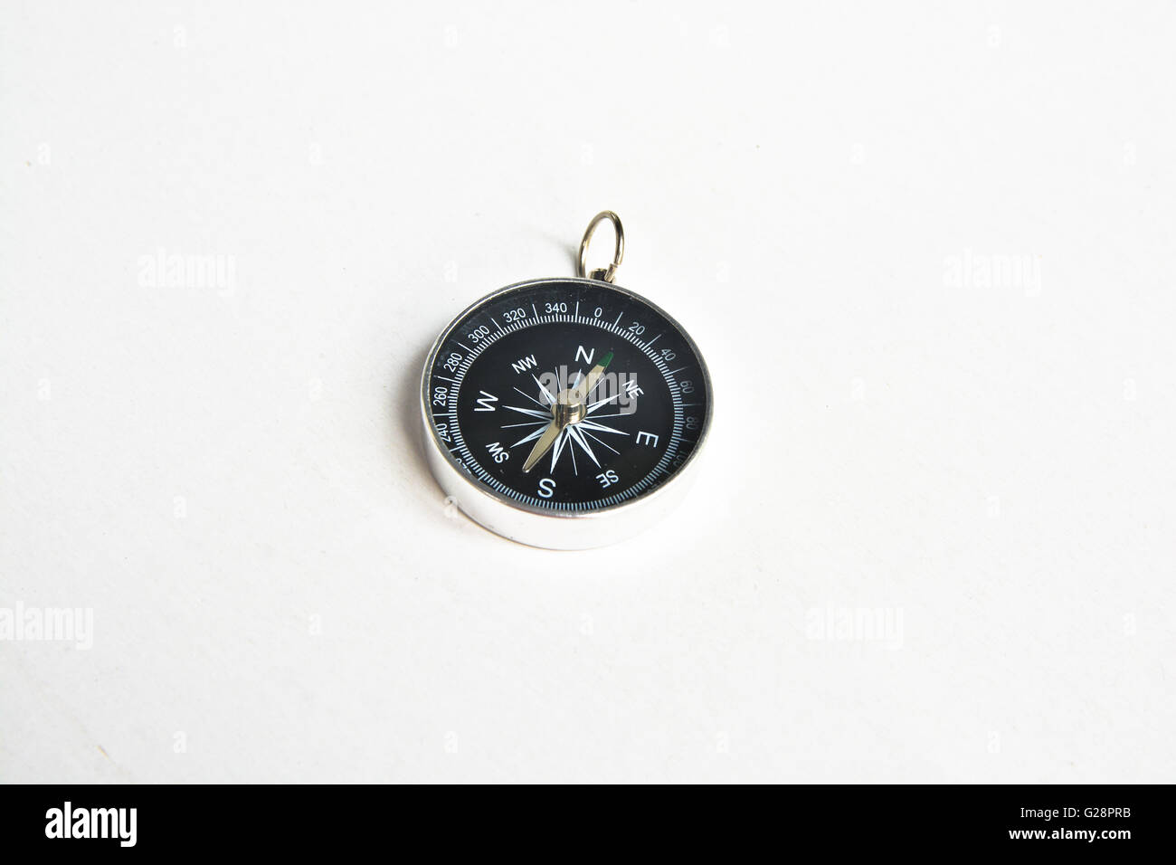 Lone compass. The magnetic compass is located on a white background. Stock Photo