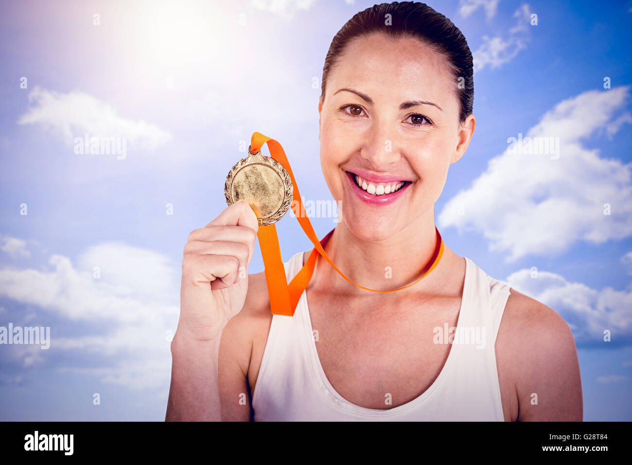 Composite image of female athlete posing with gold medals after victory Stock Photo