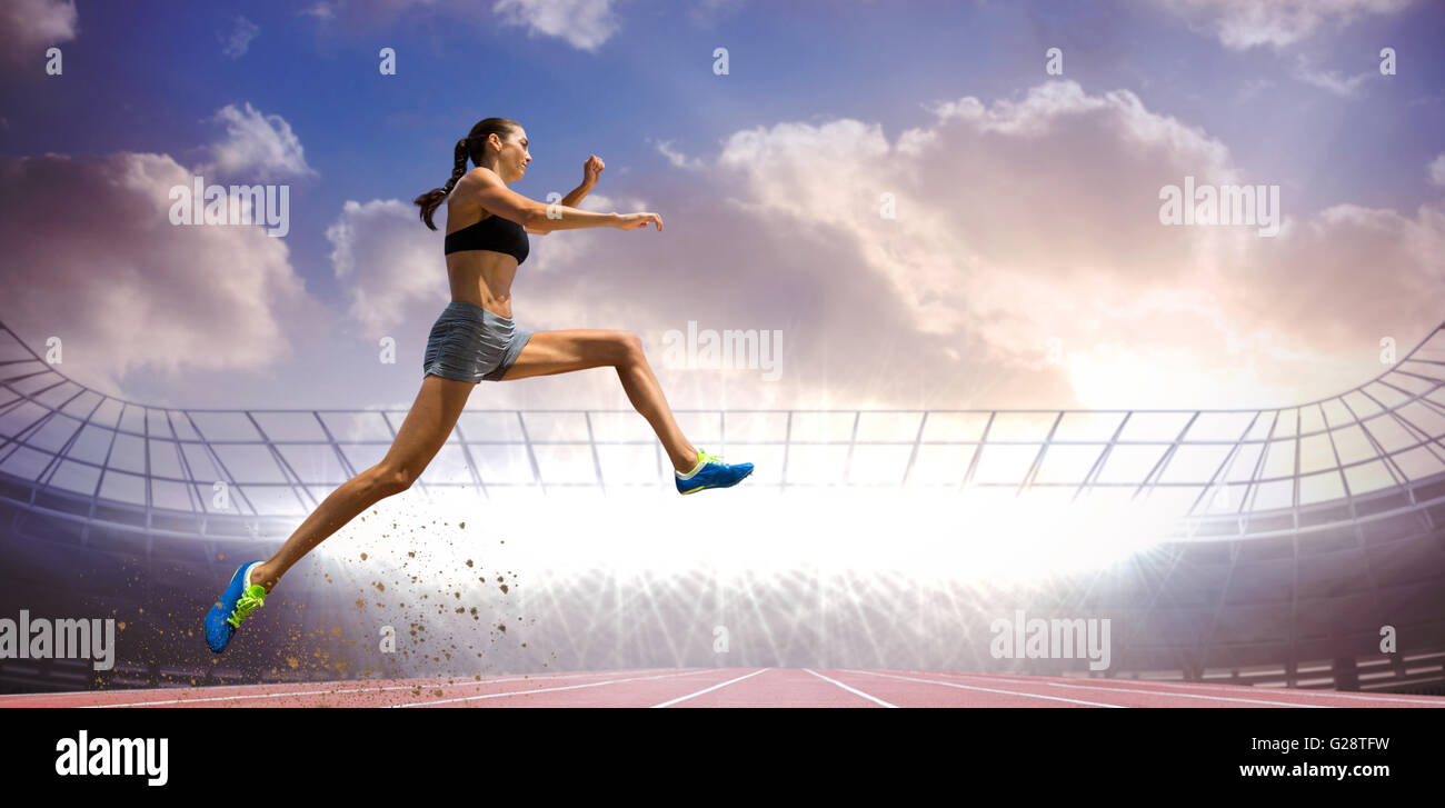 Composite image of profile view of sportswoman jumping Stock Photo