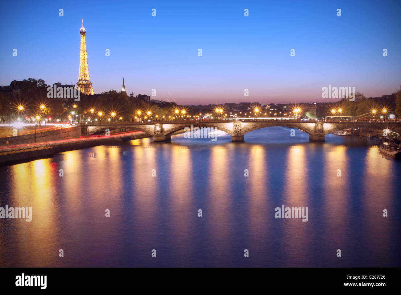 Paris, France - October 23 2011: Seine River and Eiffel Tower at dusk. The Eiffel tower is the most visited monument of France. Stock Photo