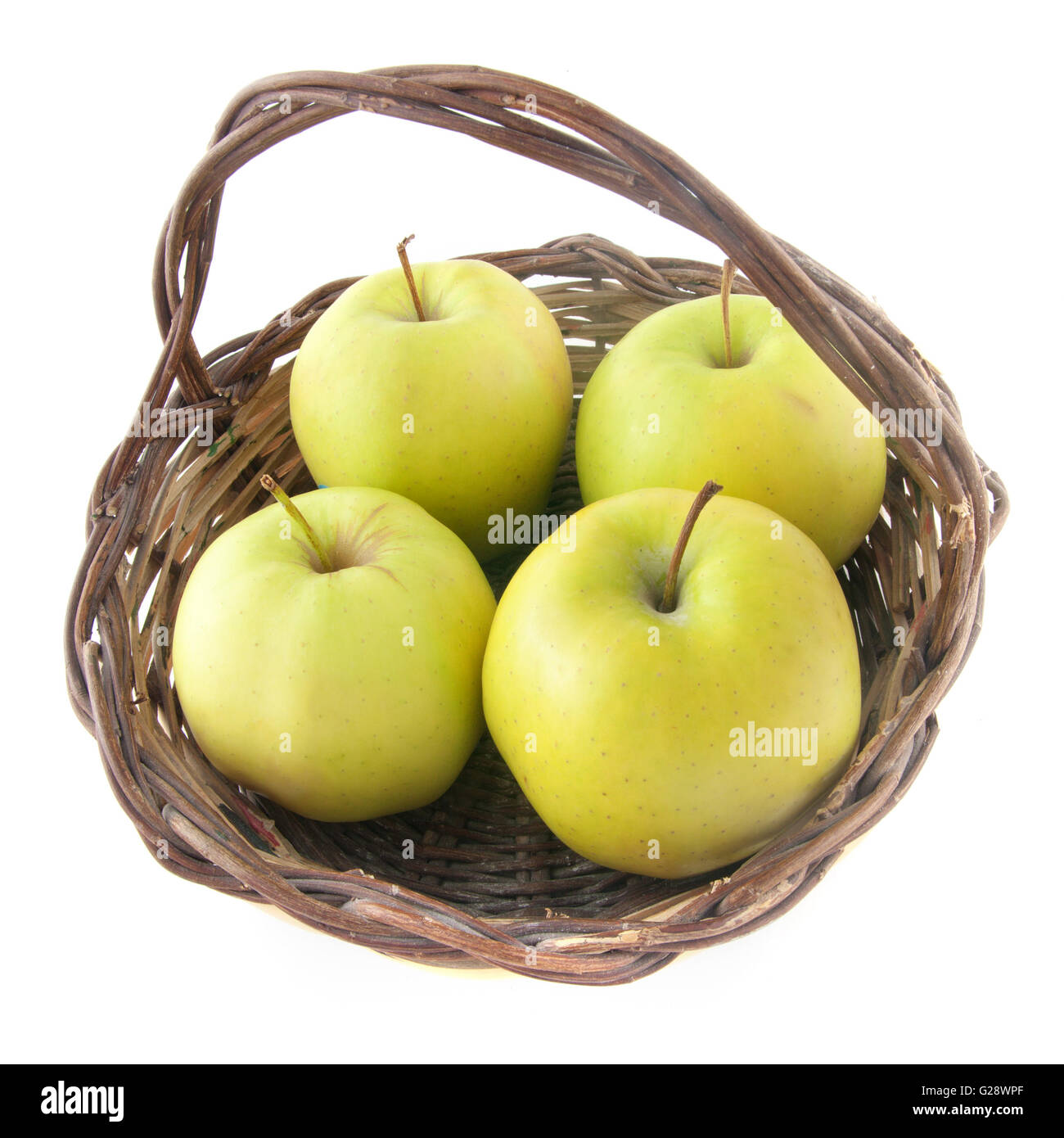 Four green apples in a wicker basket - isolated on white Stock Photo