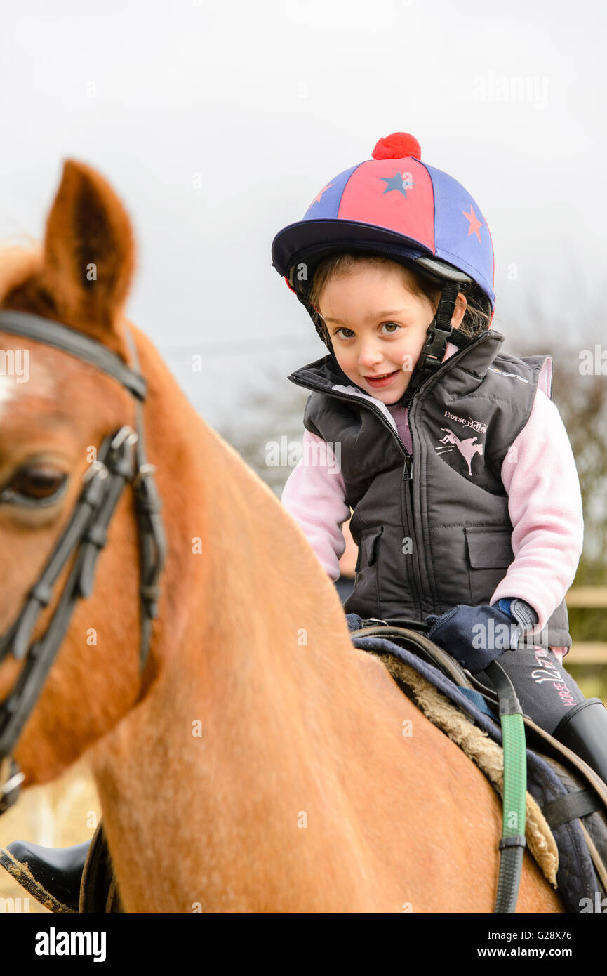 Kid riding on a horse Stock Photo - Alamy
