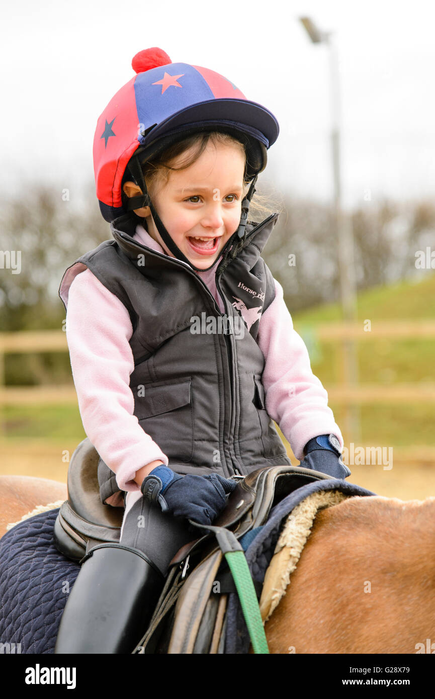Kid riding on a horse Stock Photo - Alamy
