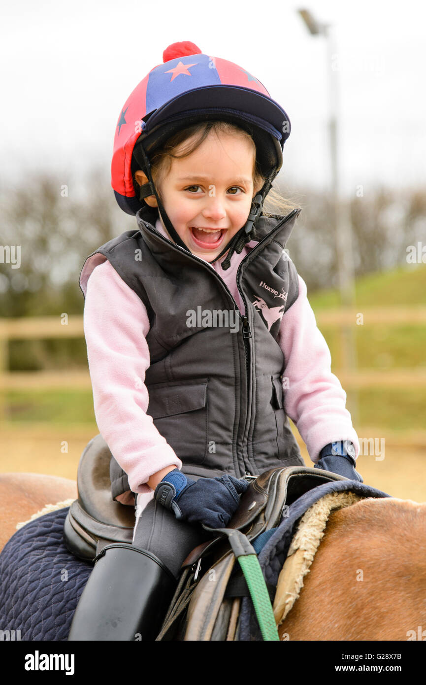 Kid riding on a horse Stock Photo - Alamy