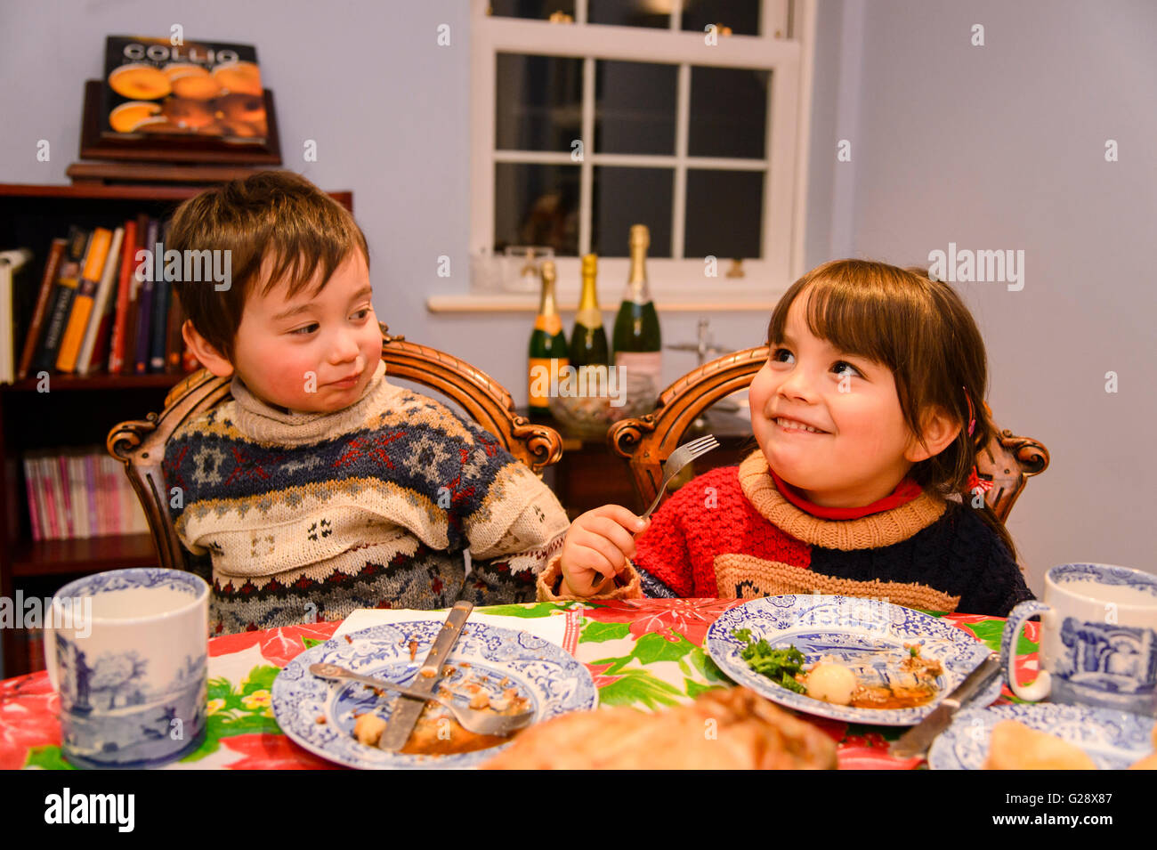 Kids eating in the house at Christmas Stock Photo