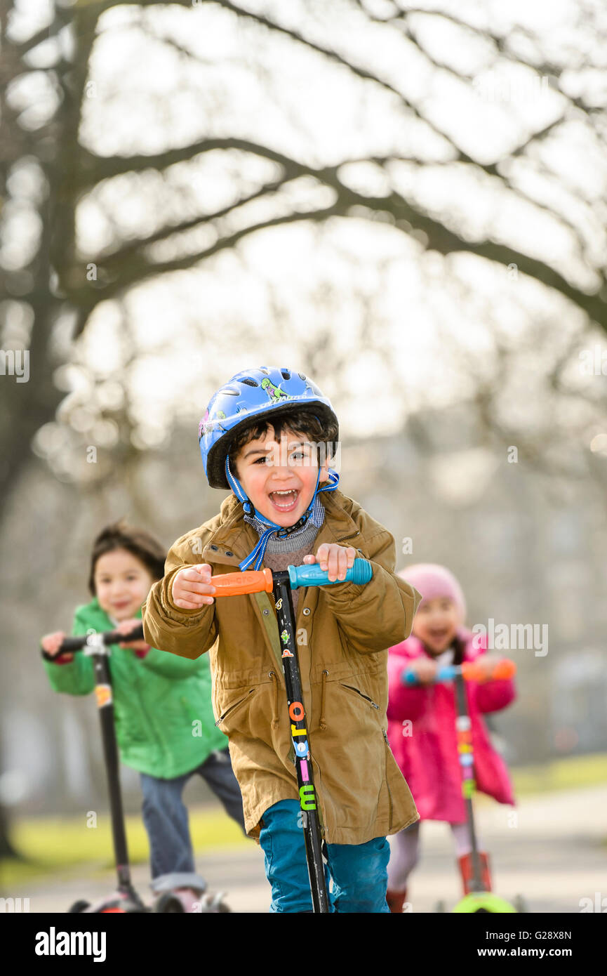 Kids playing with kickboards in a park Stock Photo Alamy