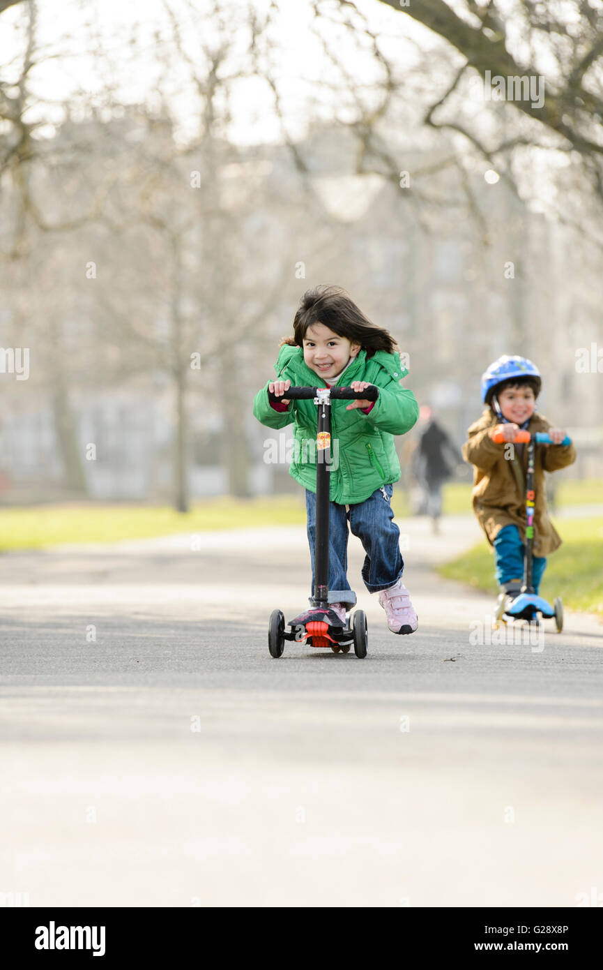 Kids playing with kickboards in a park Stock Photo Alamy