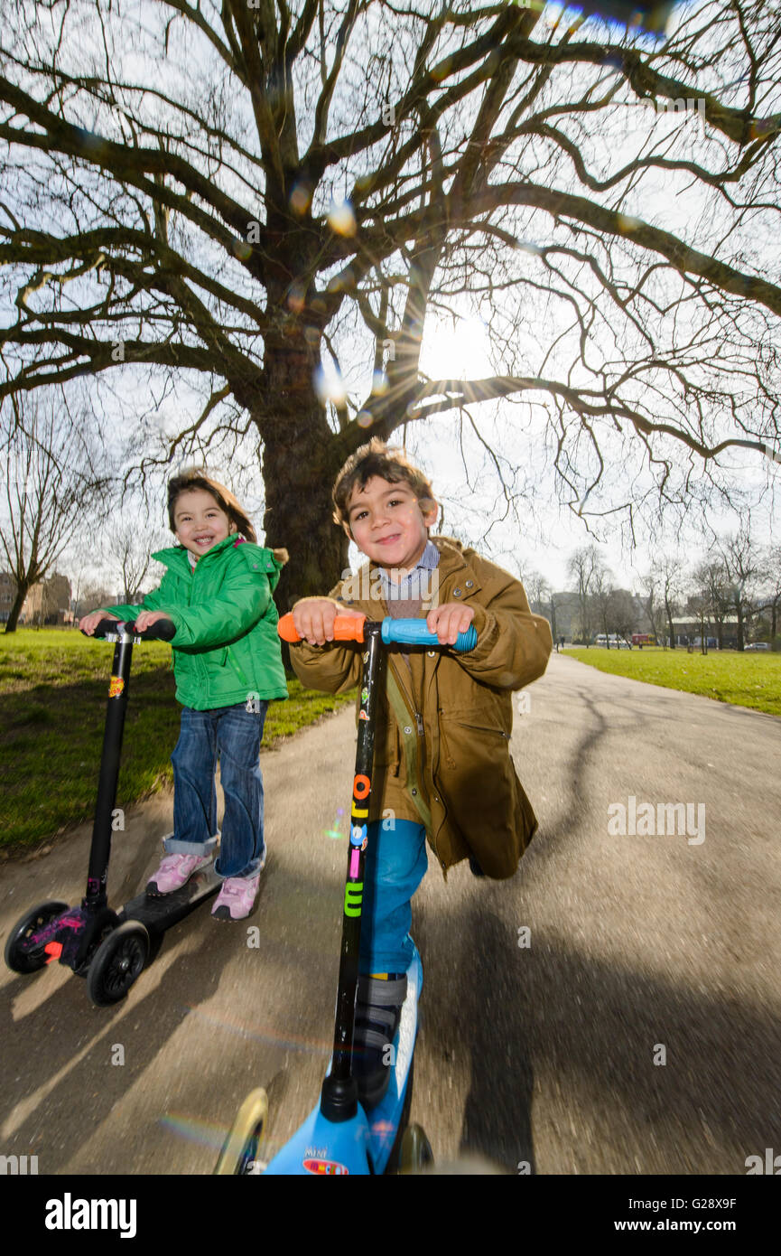 Kids playing with kickboards in a park Stock Photo Alamy