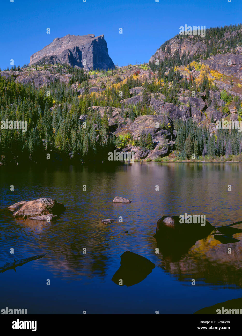 USA, Colorado, Rocky Mountain National Park, Hallett Peak and fall colored slopes above Bear Lake in early morning. Stock Photo