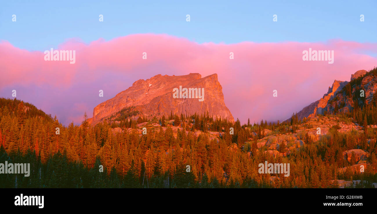 USA, Colorado, Rocky Mountain National Park, Sunrise reddens Hallett Peak and clouds above Bear Lake. Stock Photo