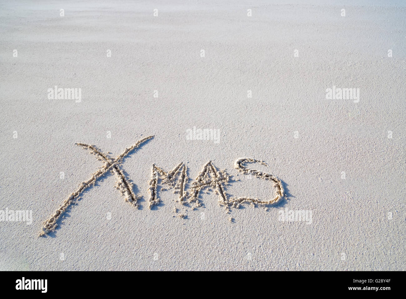 Merry Christmas text on the beach (free space for additional text) Stock Photo
