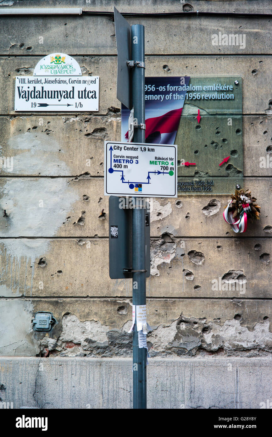 A memorial plaque and bullet holes in the wall  recall the Hungarian Revolution against the Communist dictatorship in 1956. Stock Photo
