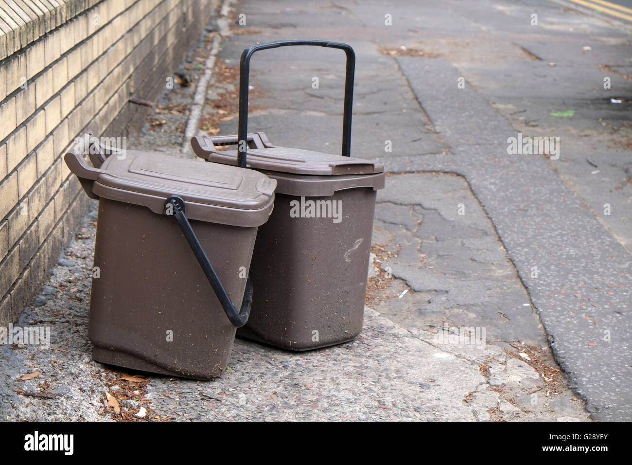 Waste food brown recycling bins left on the street for collection in