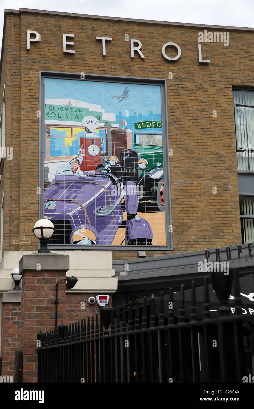 A wall painting of an old petrol station above Byron restaurant in Bloomsbury London Stock Photo
