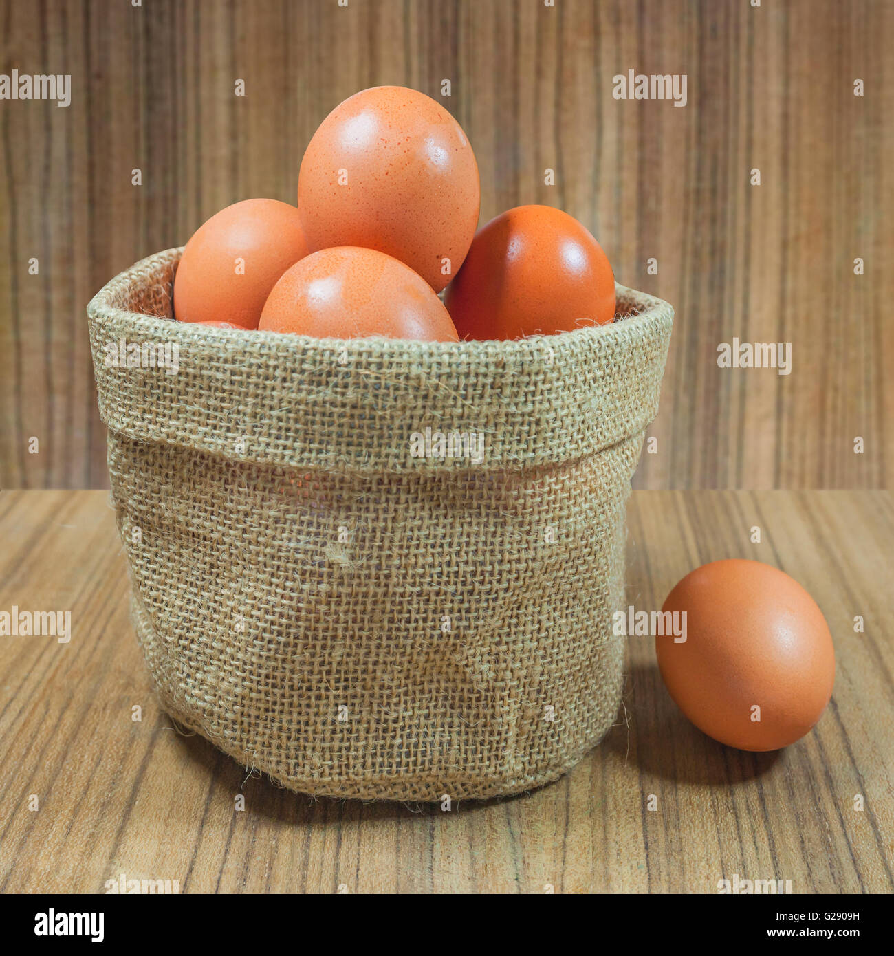 Eggs in basket on wood.eggs.egg.brown.rawfood. Stock Photo