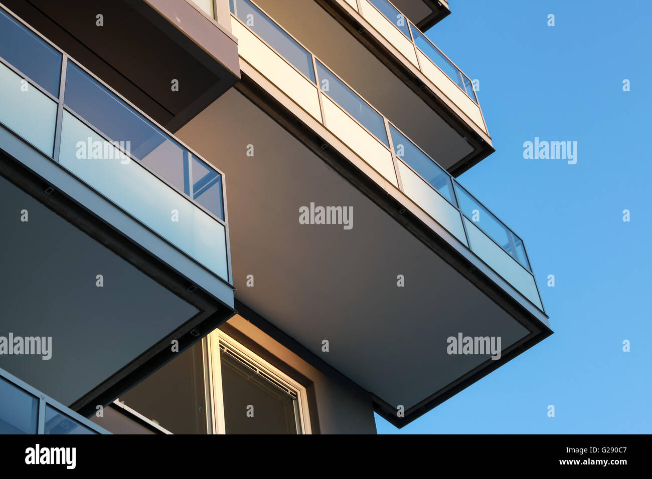 Abstract fragment of contemporary architecture, balconies with glass railings Stock Photo