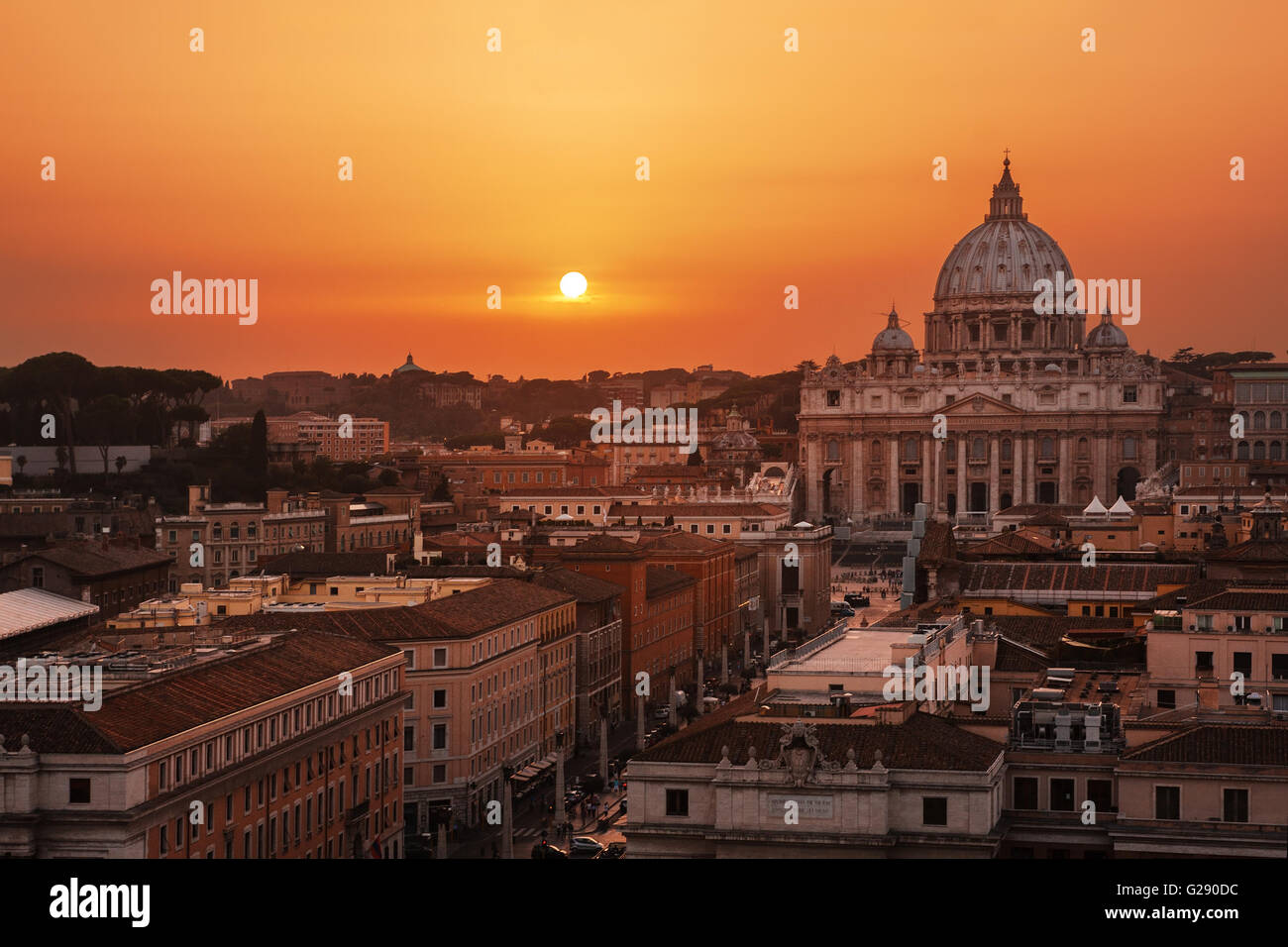 Beautiful sunset over Rome (Italy) and Vatican City. St. Peter's Basilica on background. Stock Photo