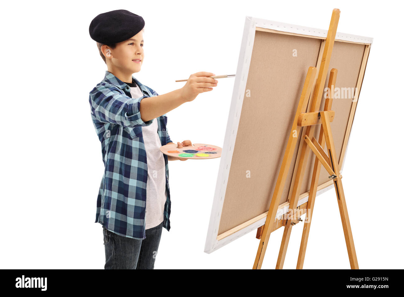 Little kid painting on a canvas with a paintbrush isolated on white background Stock Photo