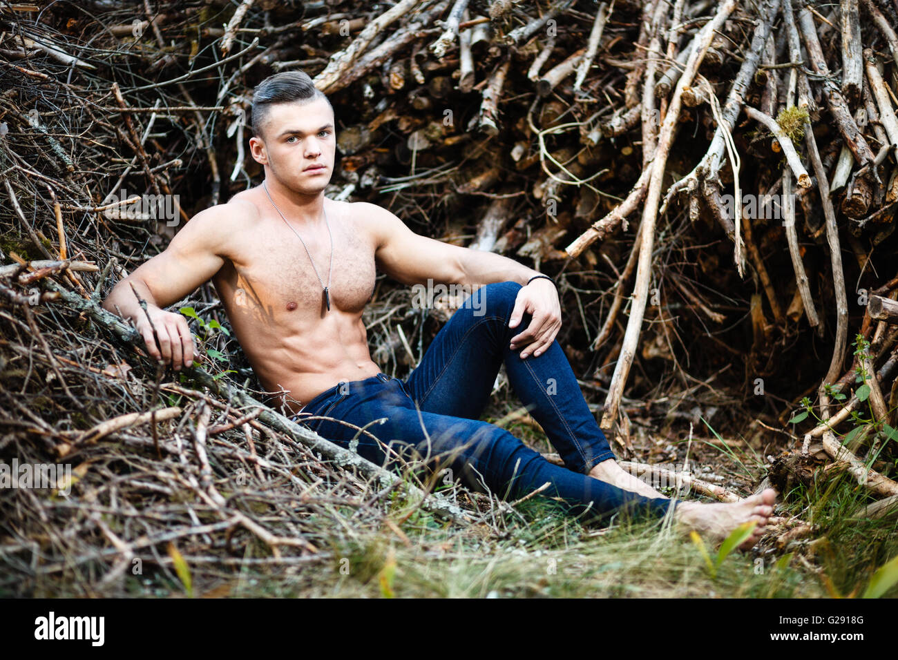 Muscular man in forest Stock Photo