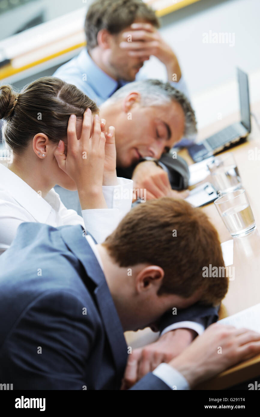 Business people sleeping in the conference room during a meeting, focus ...