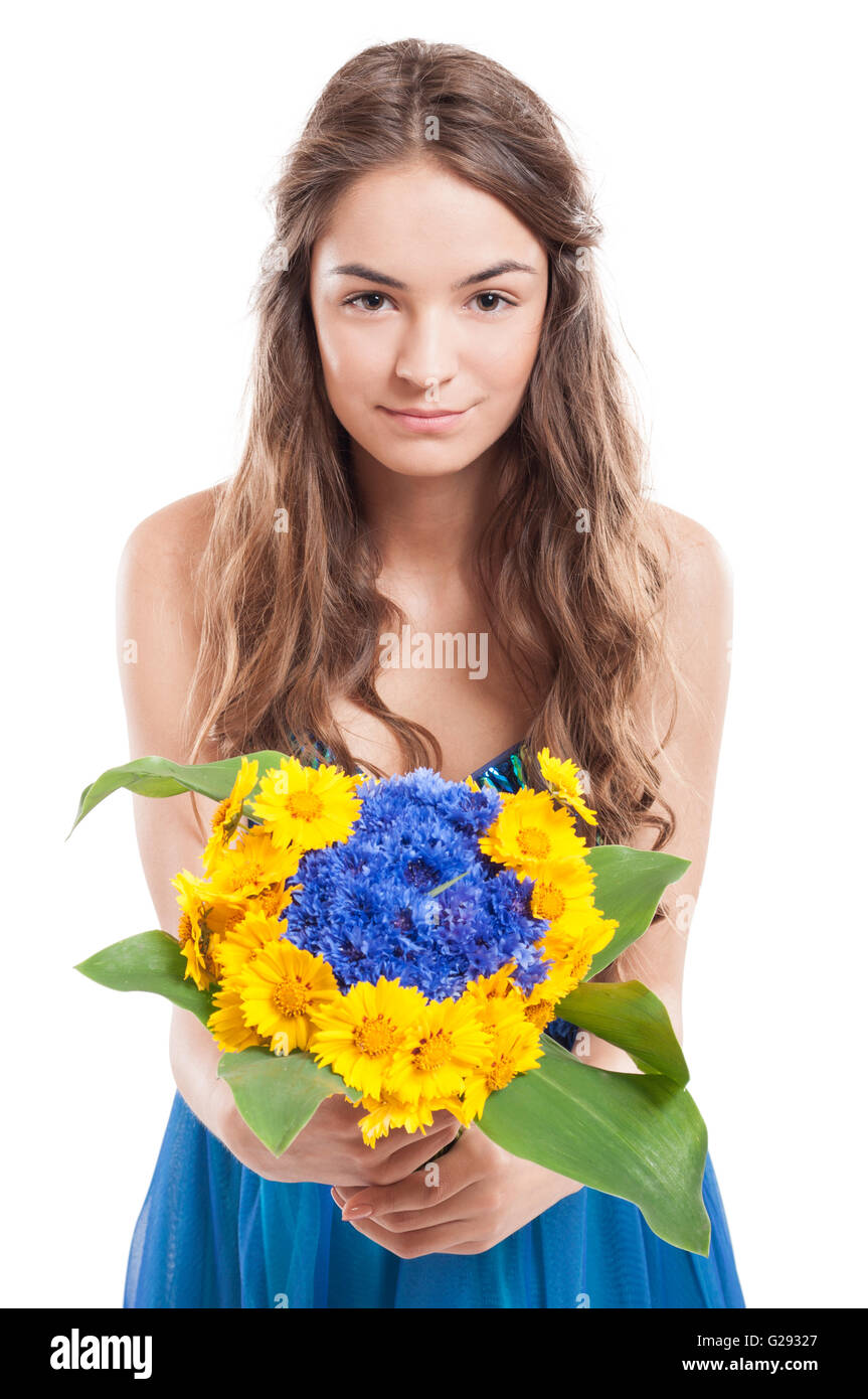 Young female model with long hair offering a bouquet of flowers Stock ...