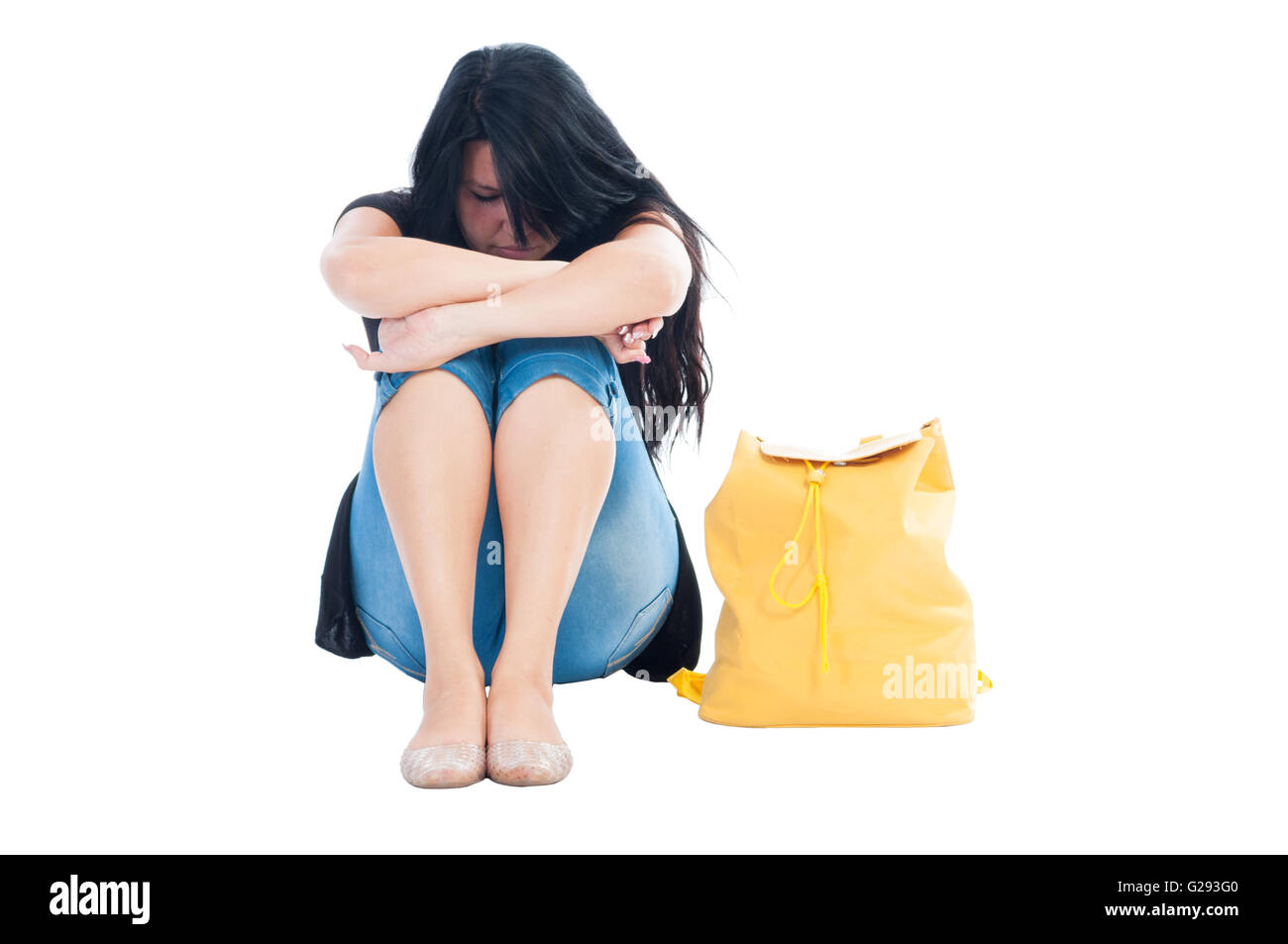 Upset girl sitting on white background Stock Photo - Alamy