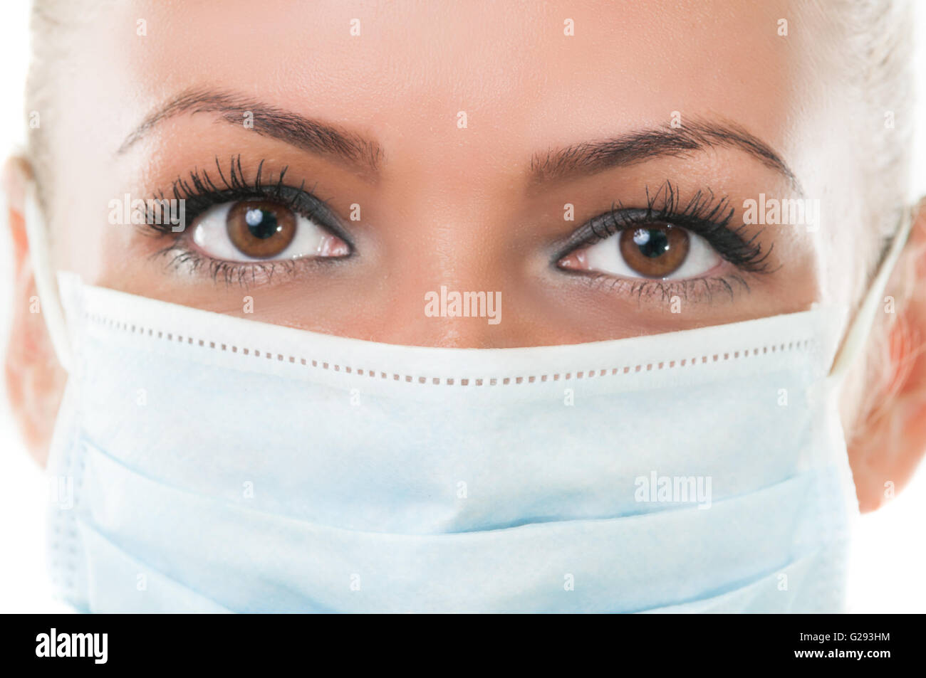 Closeup of the eyes of a dentist assistant wearing hospital  mask Stock Photo