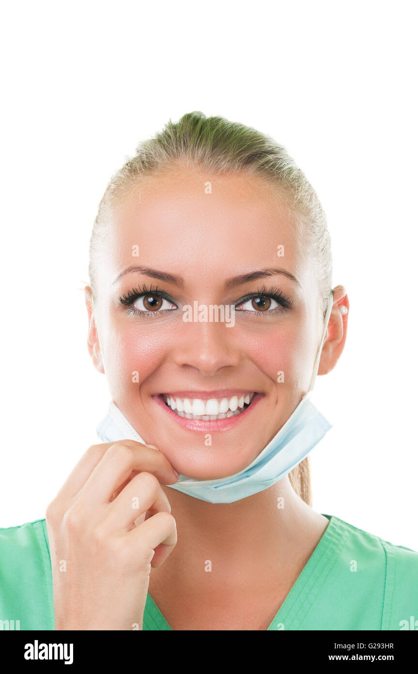 Beautiful dentist assistant with perfect smile wearing a surgical mask Stock Photo