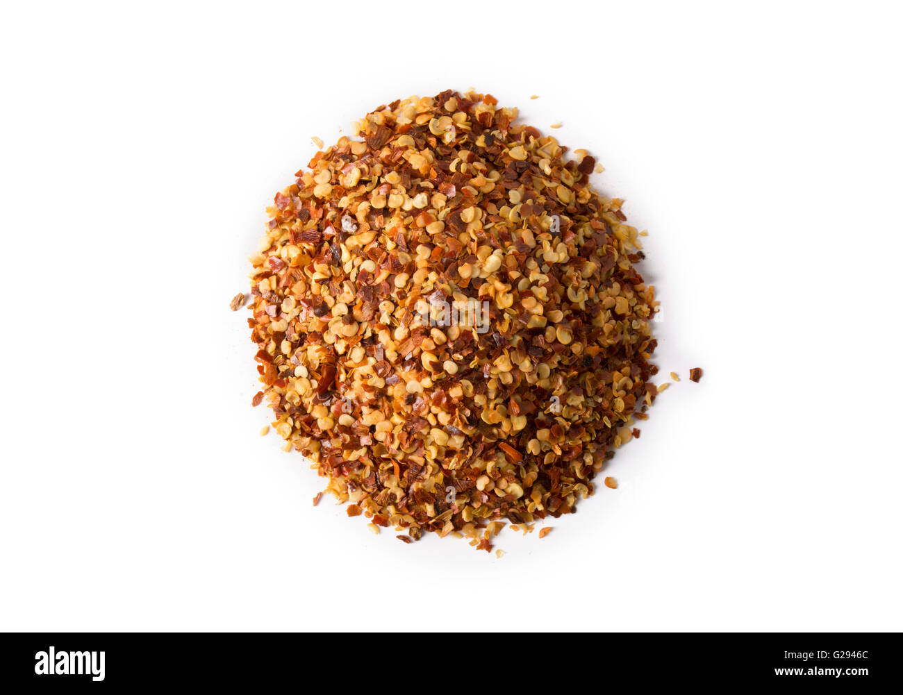 A pile of crushed red pepper flakes on white with slight shadow. Stock Photo