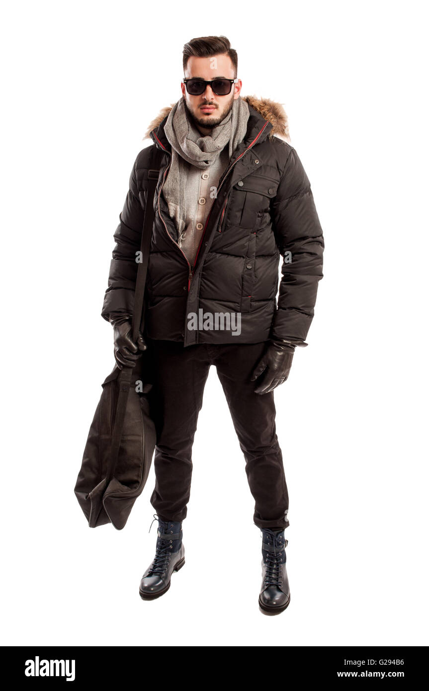Fashionable male model wearing winter clothes and a big bag on his shoulder Stock Photo