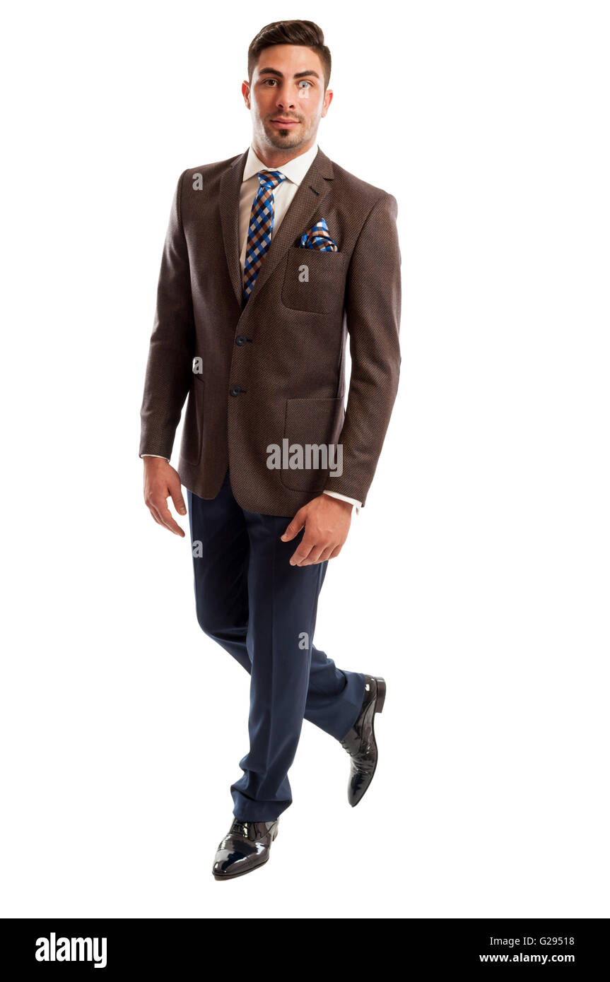 Brunet male model wearing elegant and fashionable suit and posing isolated on white background Stock Photo