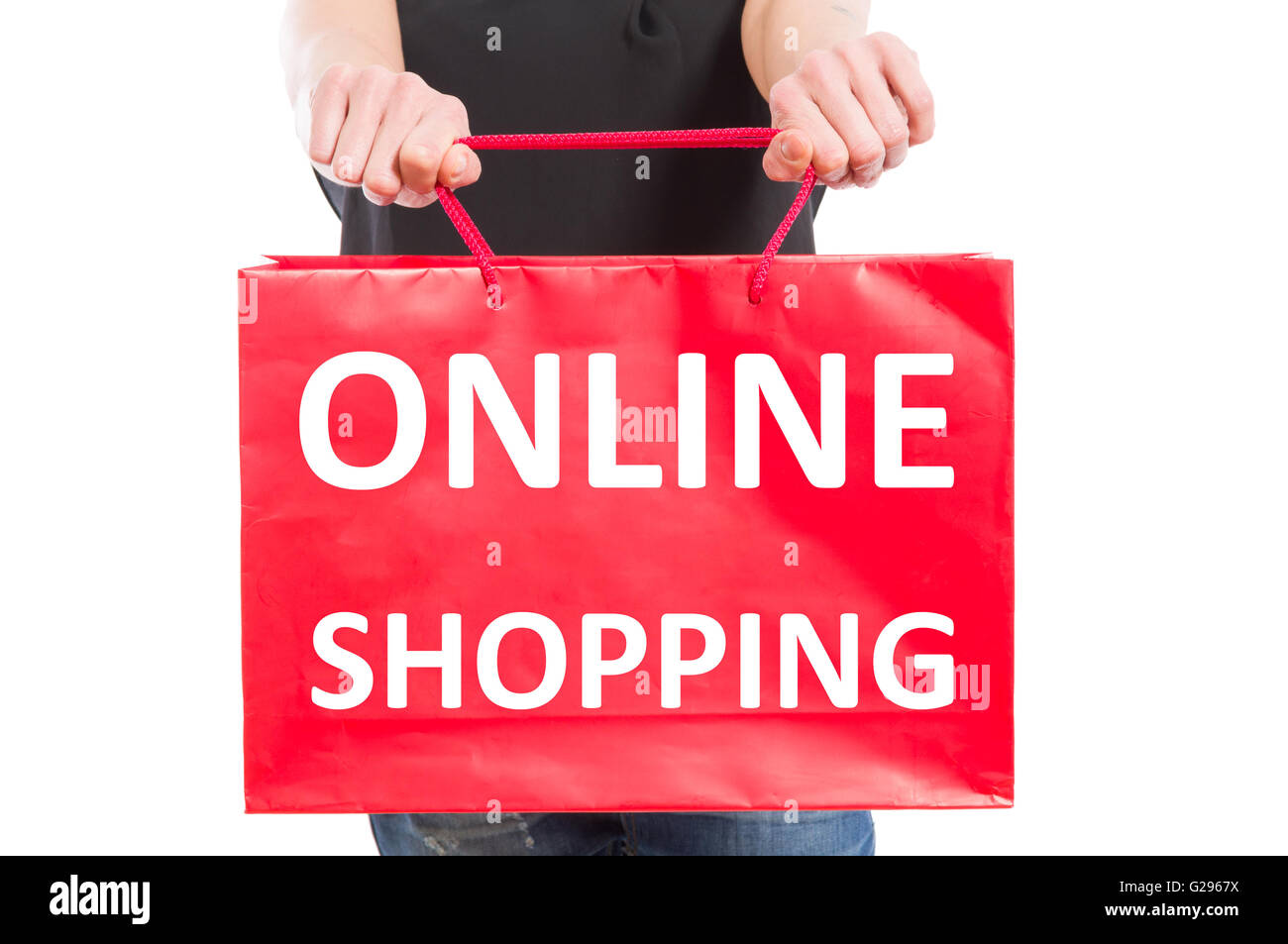 Online shopping concept with a woman holding a red paper gift bag Stock Photo