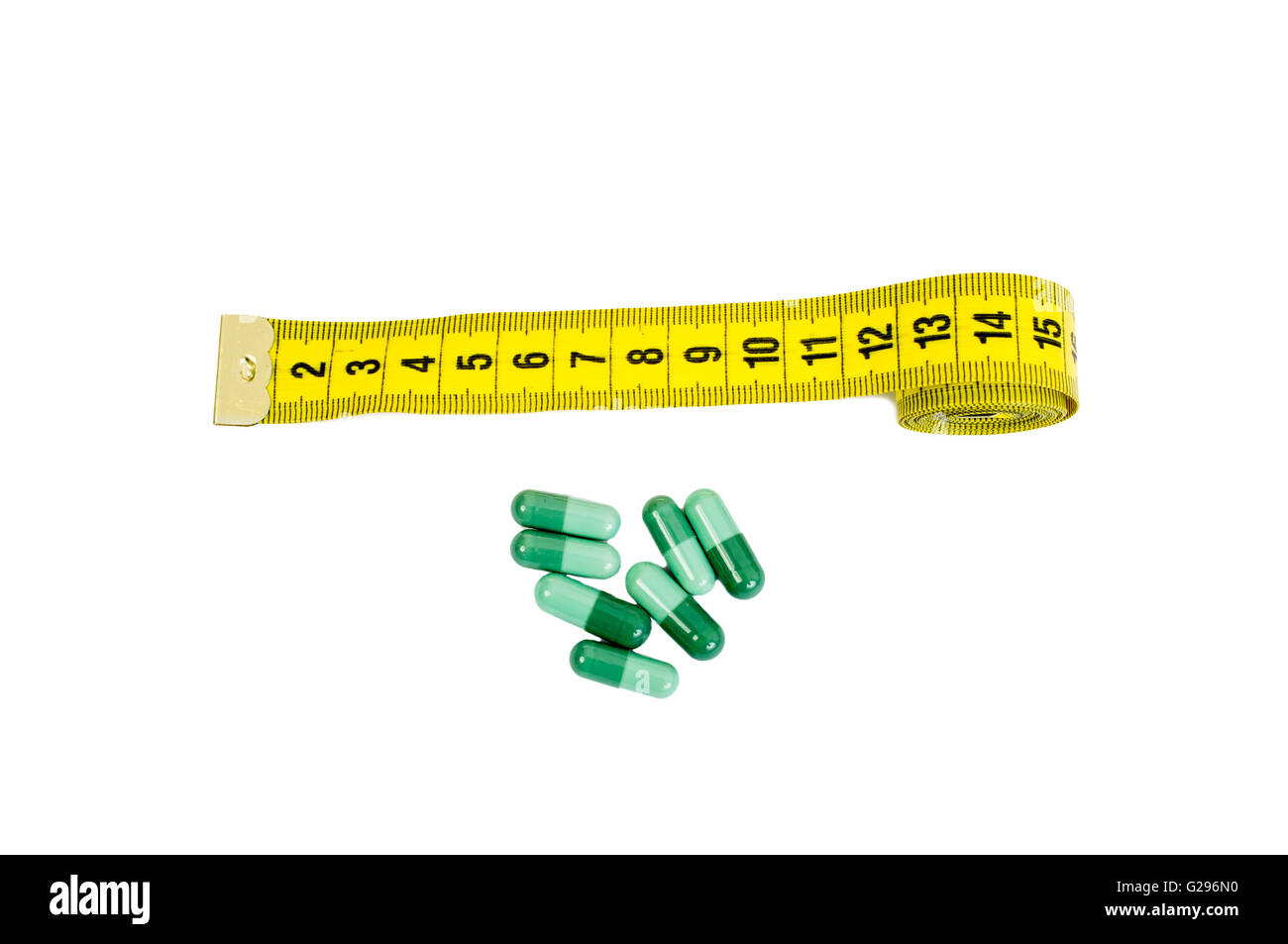 Tailor meter and green herbal pills. Natural slim diet pills concept Stock Photo
