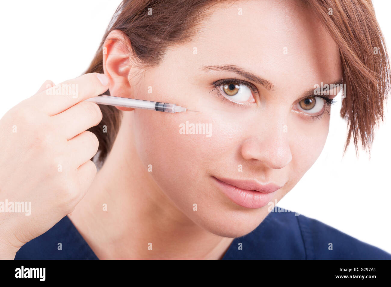 Plastic surgery doctor injecting botox near eye using syringe Stock