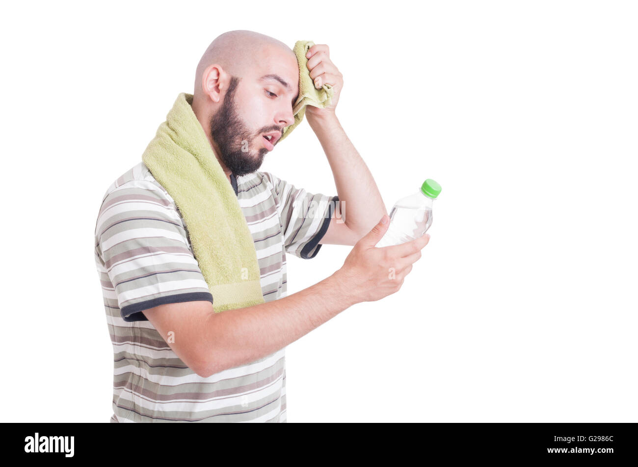 Dehydrated man wiping forehead and holding bottle of water isolated on white Stock Photo