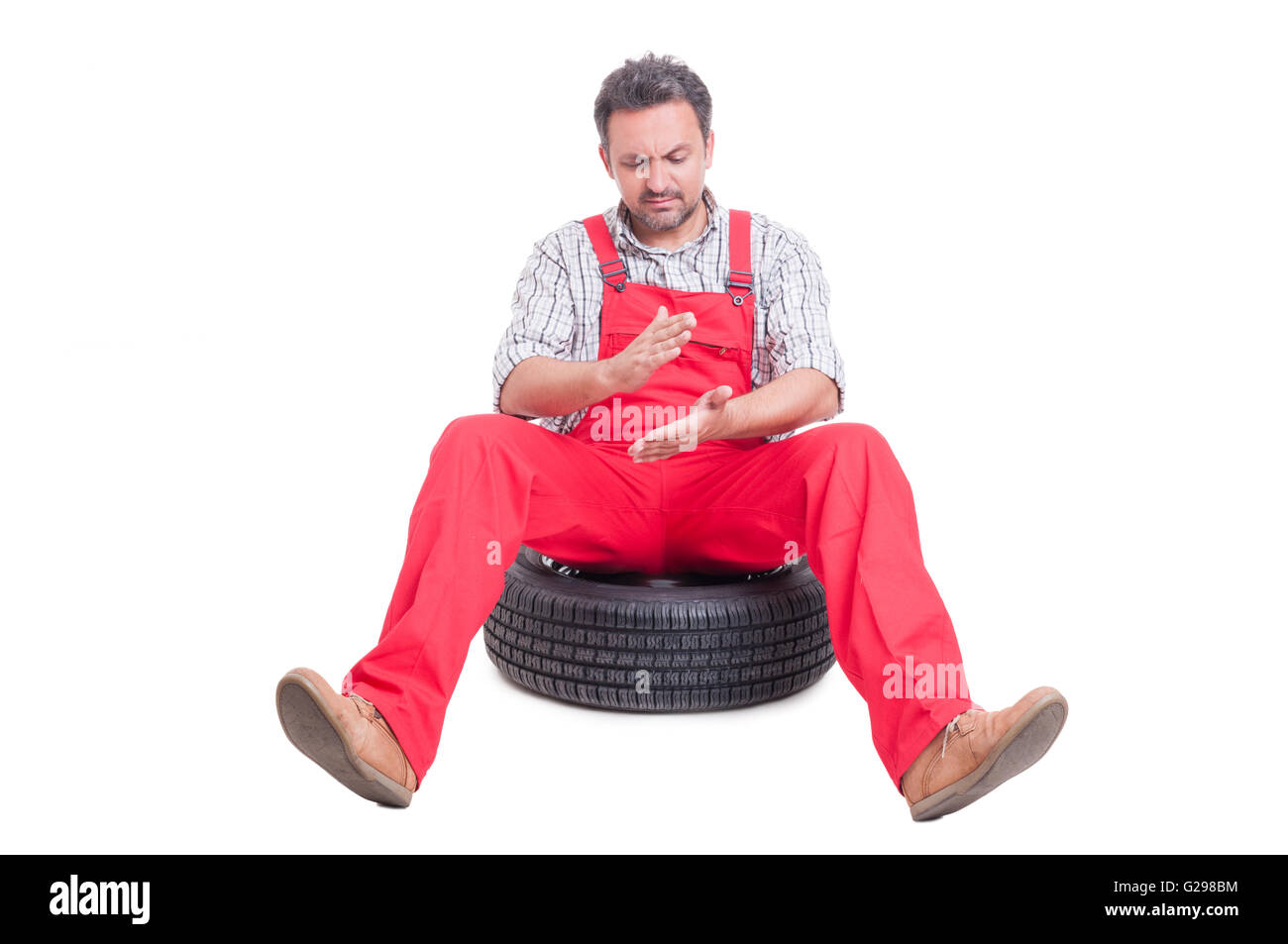 Mechanic cleaning his dirty hands by clapping them to remove the dust Stock Photo