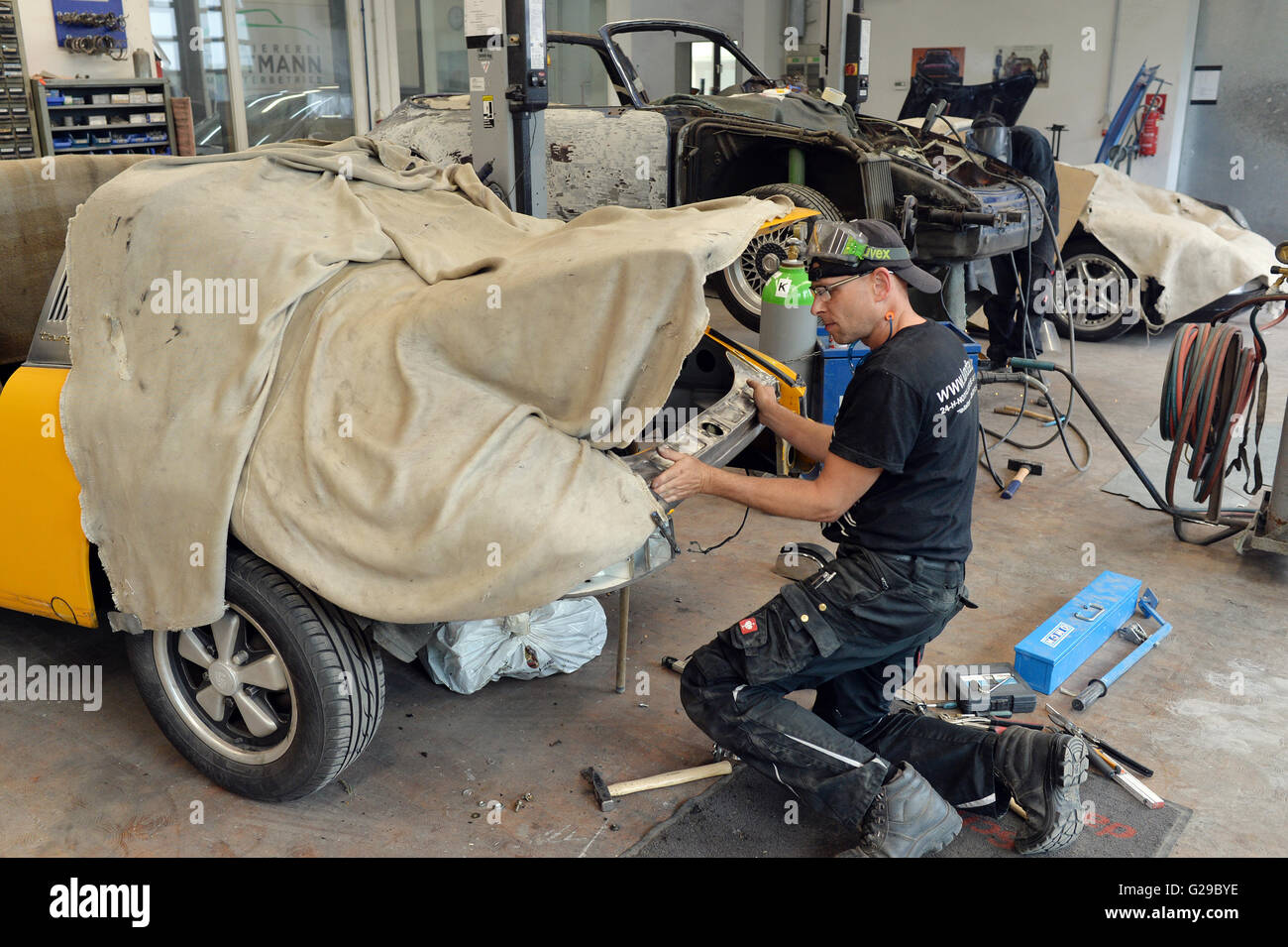 Berlin, Germany. 23rd May, 2016. An coachbuilder repairs a car in an ...